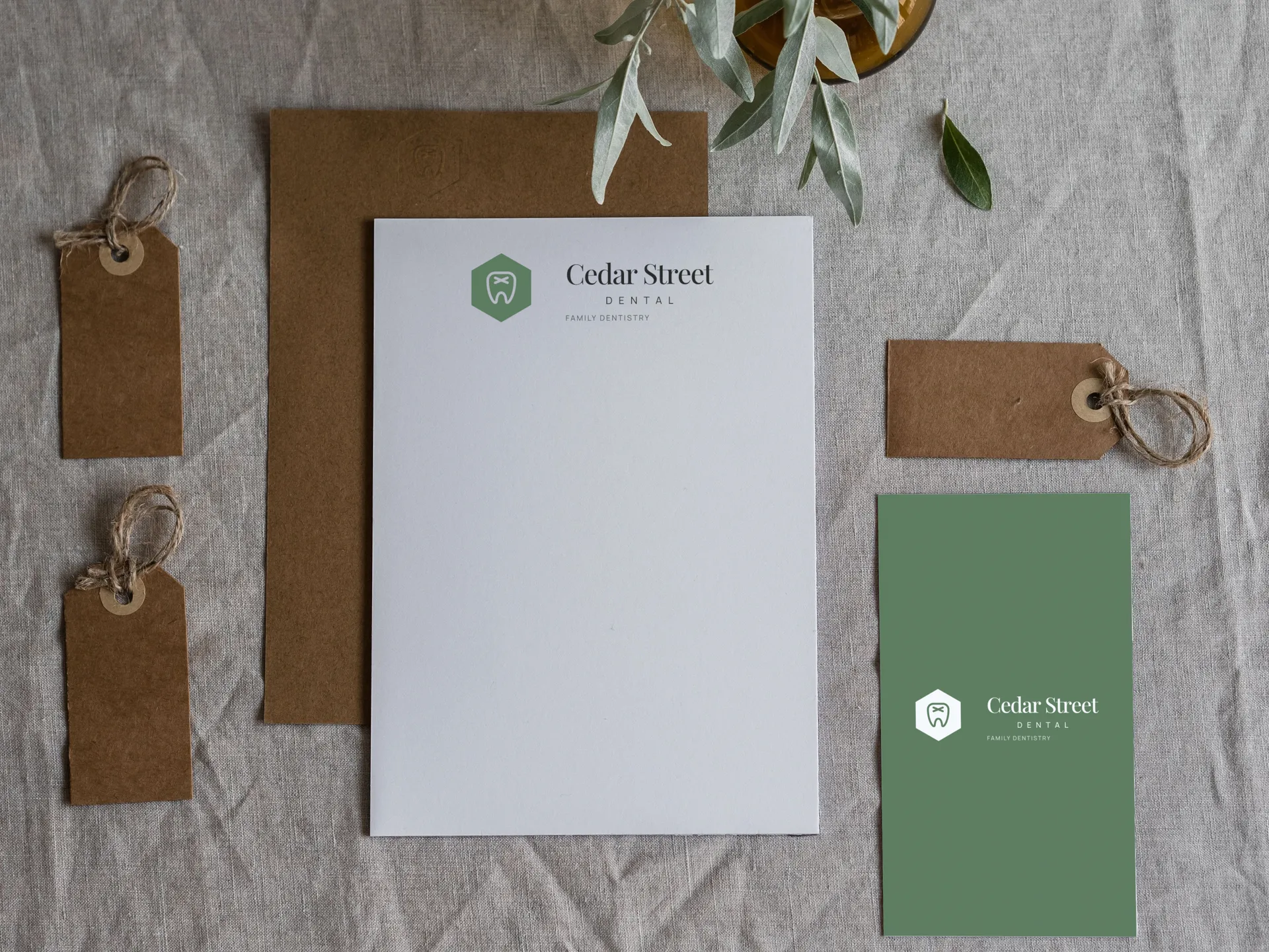 Cedar Street Dental logo on folder, letterhead and card