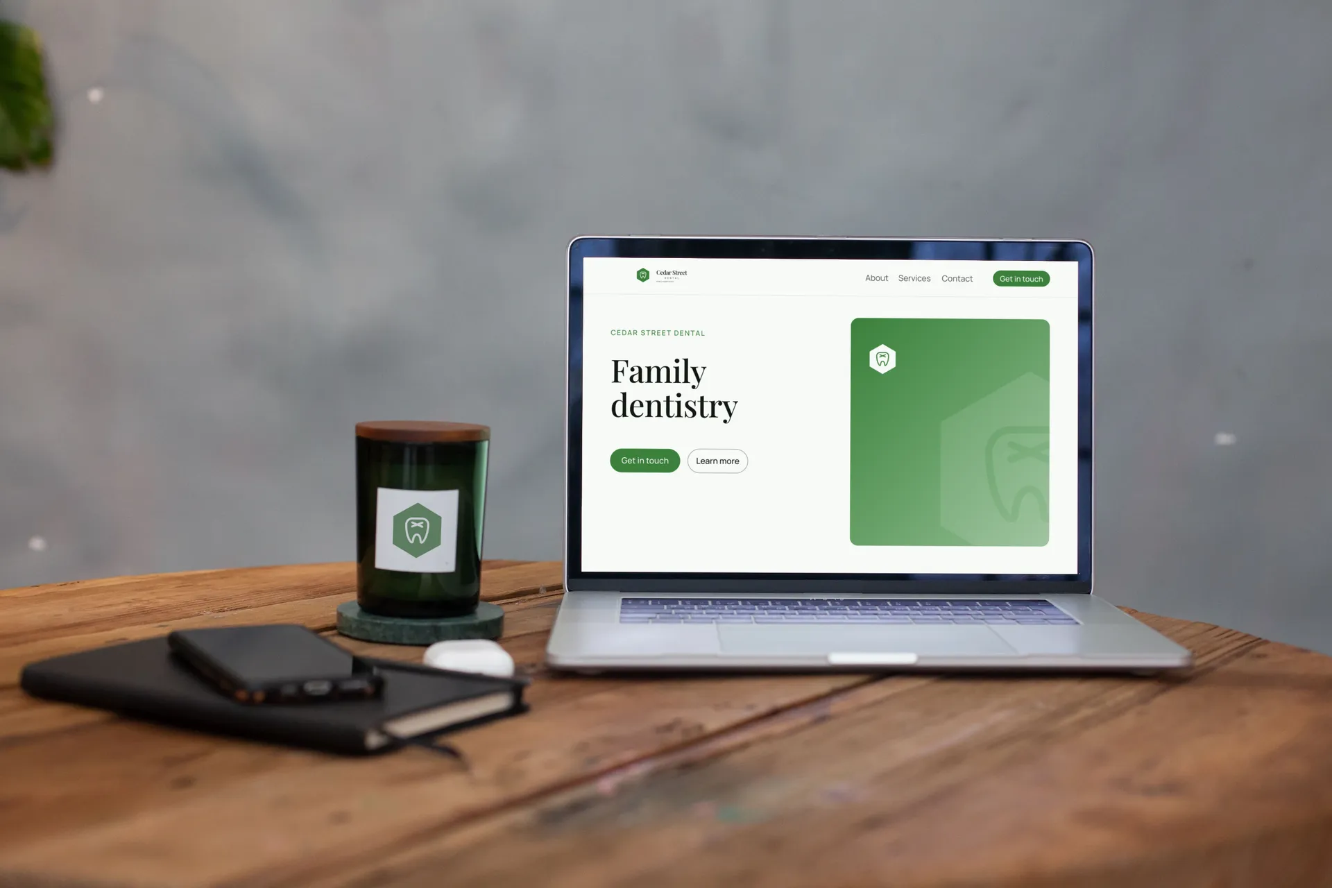 Cedar Street Dental logo on laptop on a wood desk