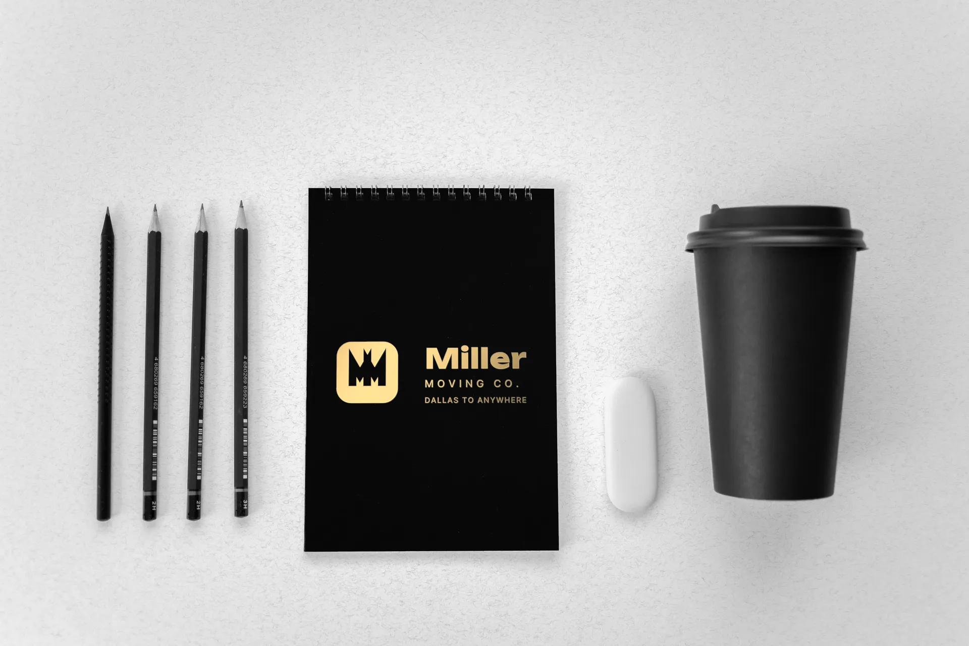 Miller Moving Co. logo on black notebook with pencils