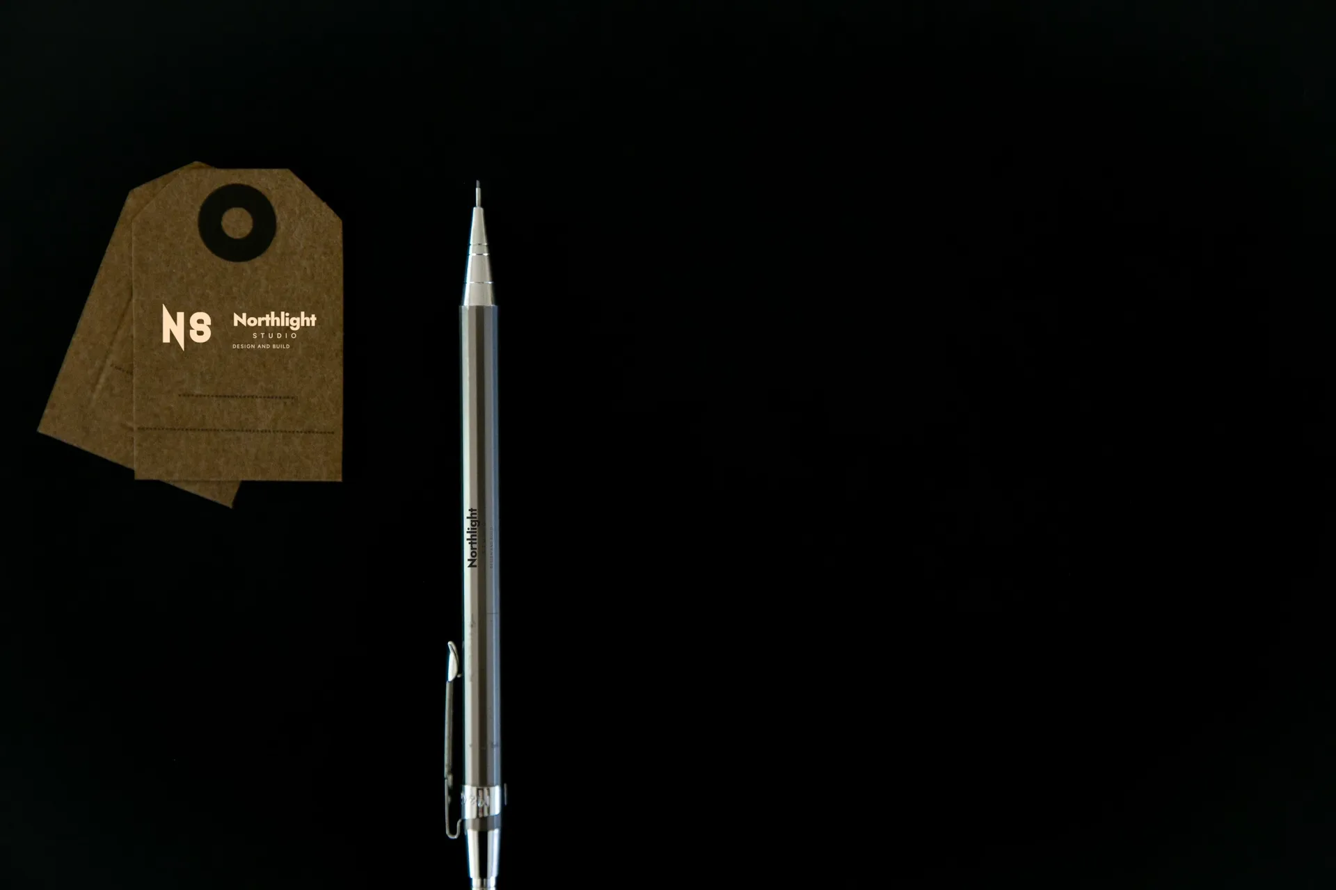 Northlight Studio logo on pencil and tag on black