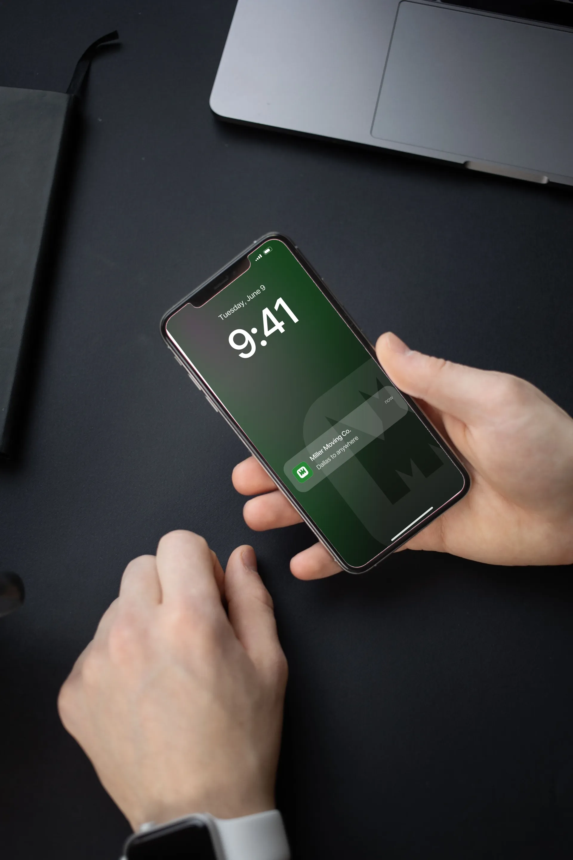 Miller Moving Co. logo on phone in hand