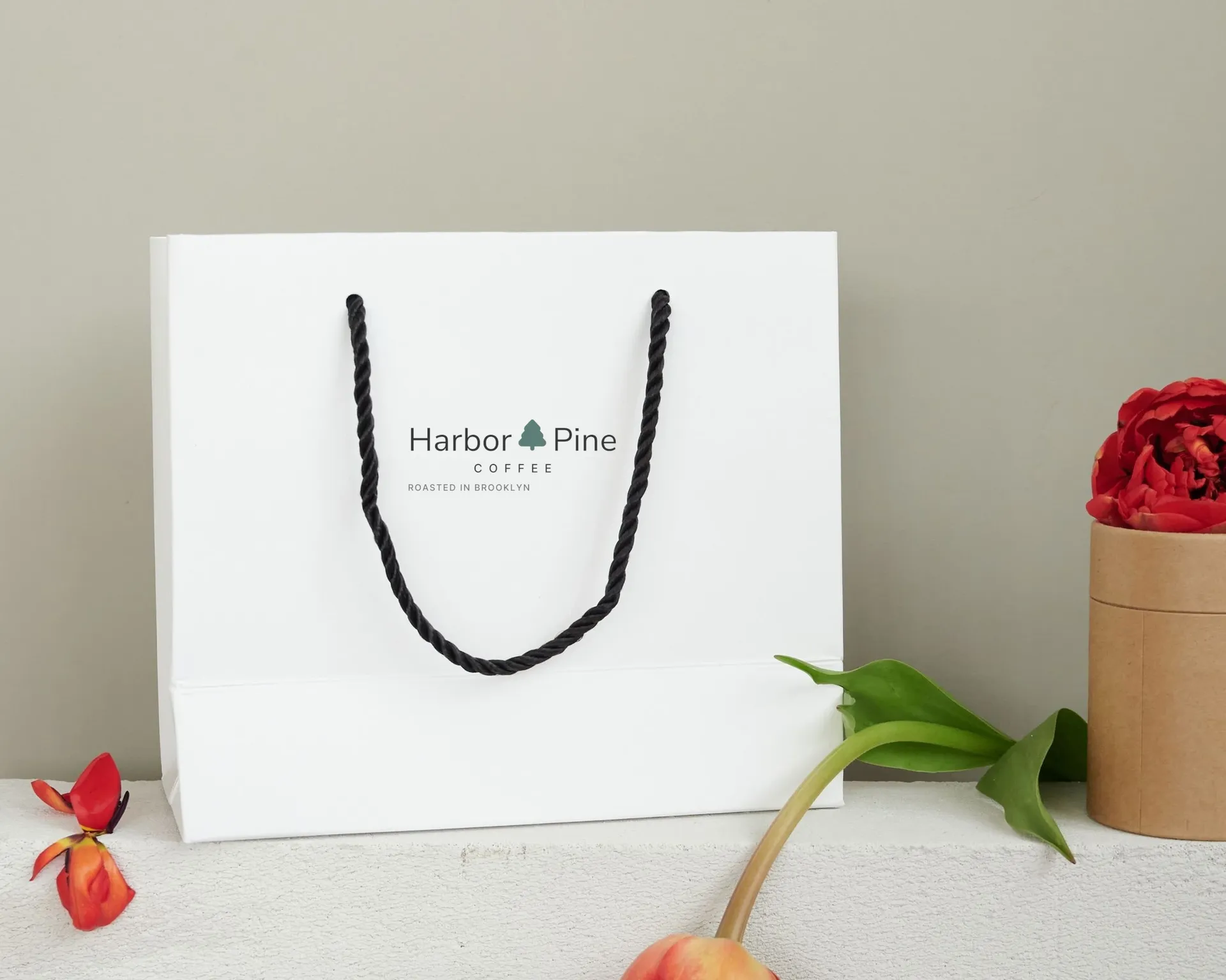 Harbor & Pine Coffee logo on shopping bag on stone