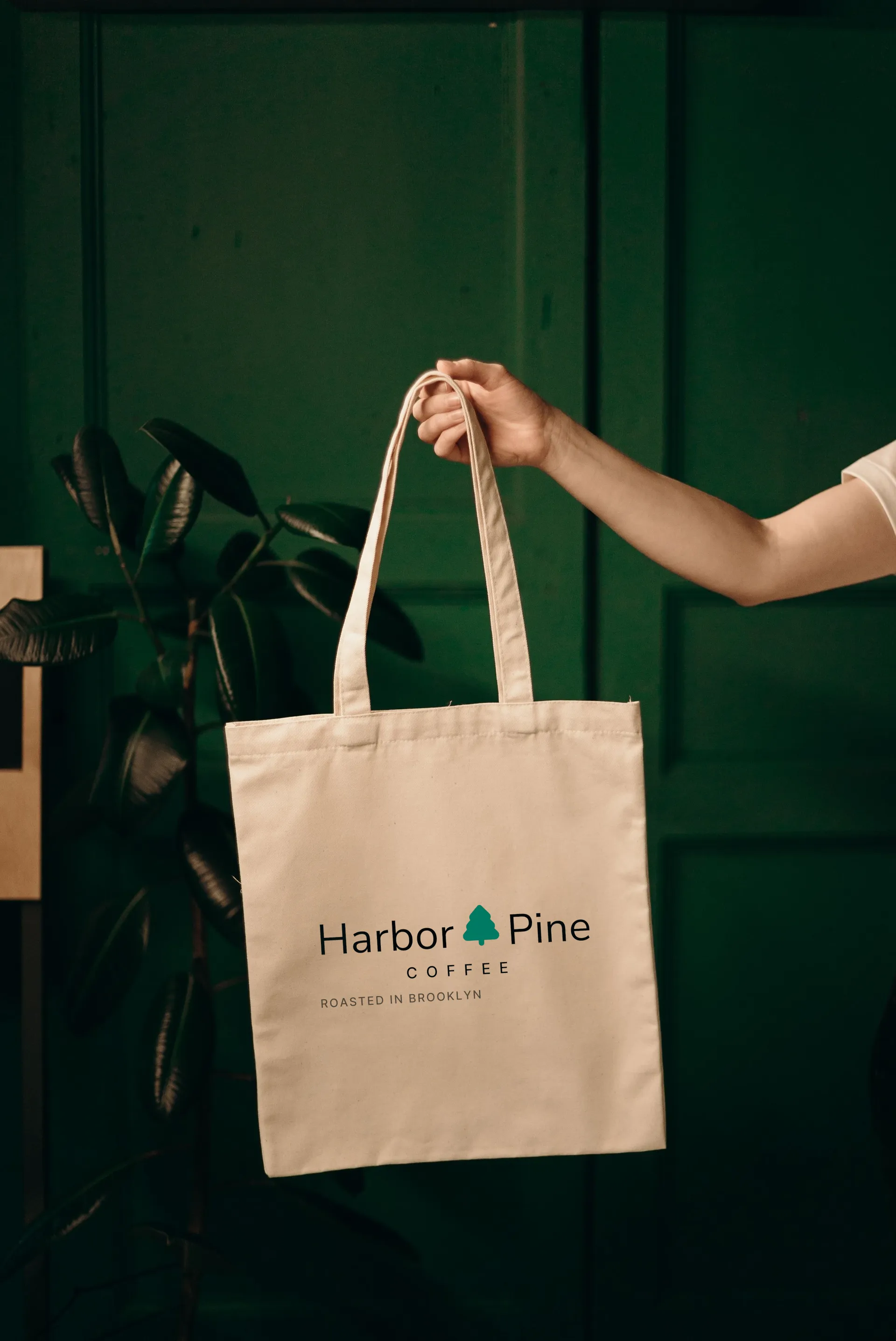 Harbor & Pine Coffee logo on canvas tote in hand