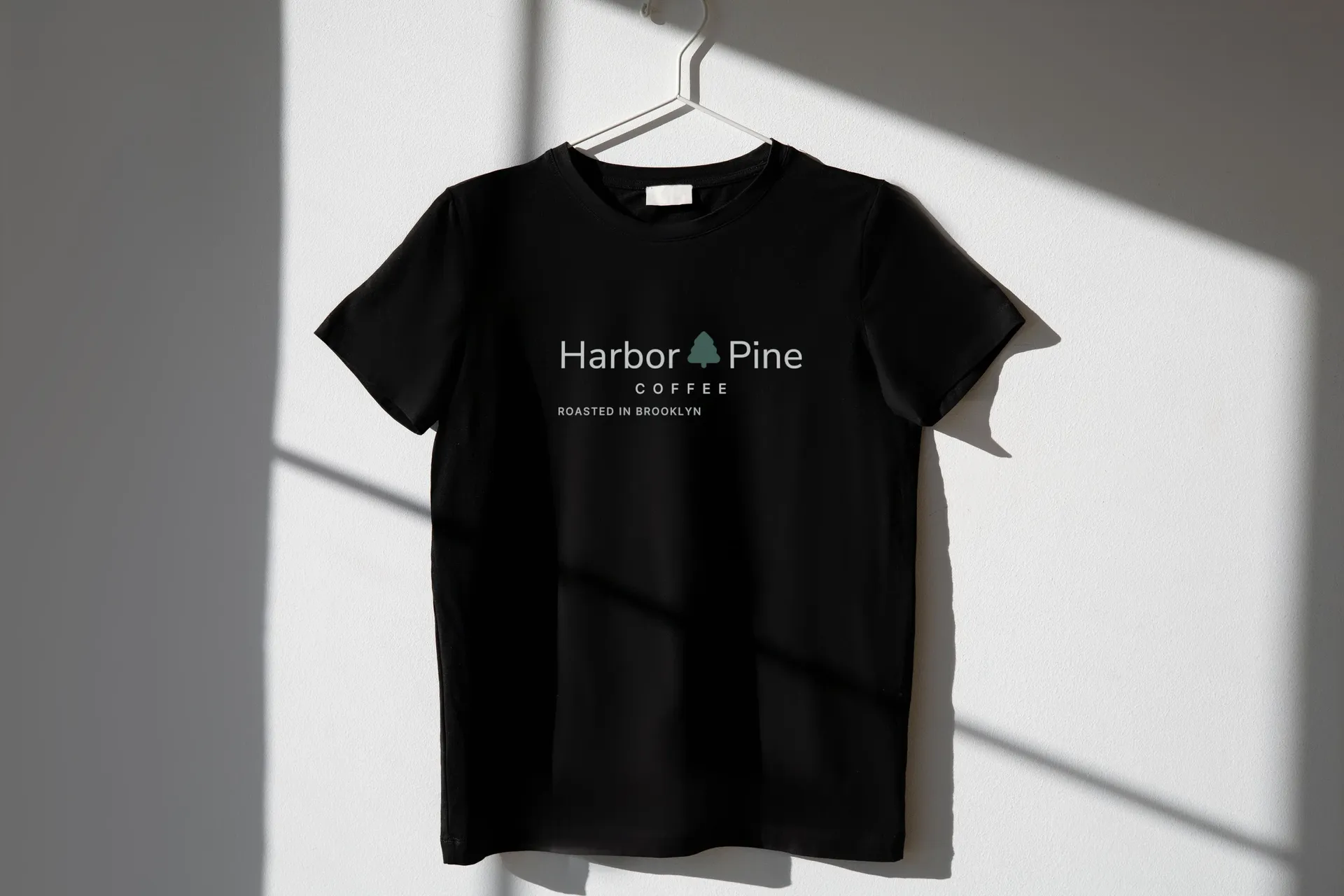 Harbor & Pine Coffee logo on tee on a hanger
