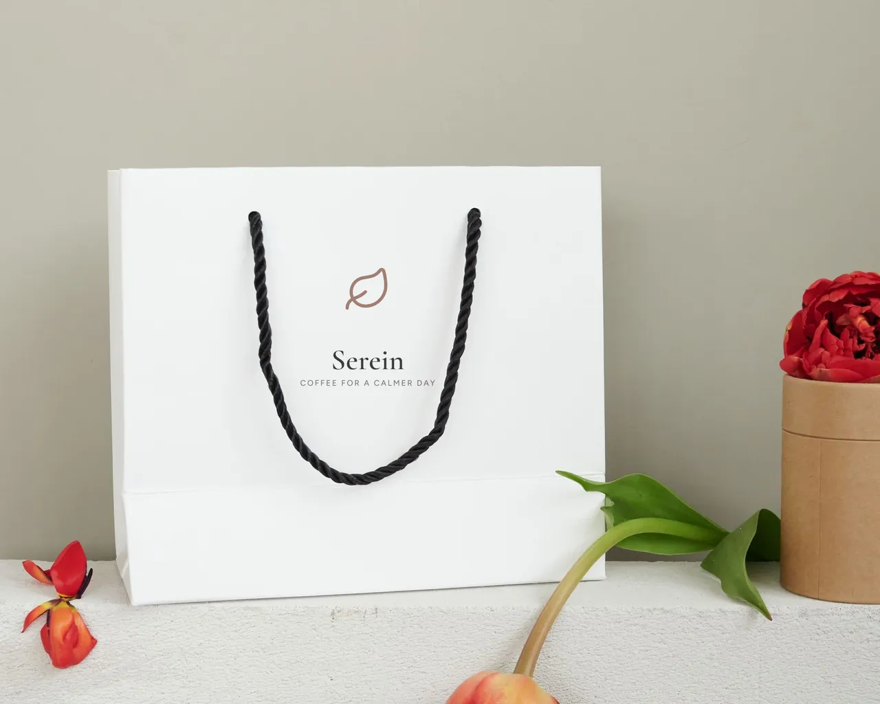 Serein logo on a shopping bag on a stone plinth, an example identity